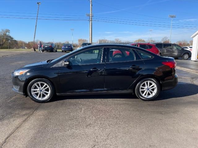 2017 Shadow Black Ford Focus SE Sedan (1FADP3F20HL) with an 2.0L L4 DOHC 16V engine, located at 1099 N County Rd 25A, Troy, OH, 45373, (937) 908-9800, 40.057079, -84.212883 - Photo #4
